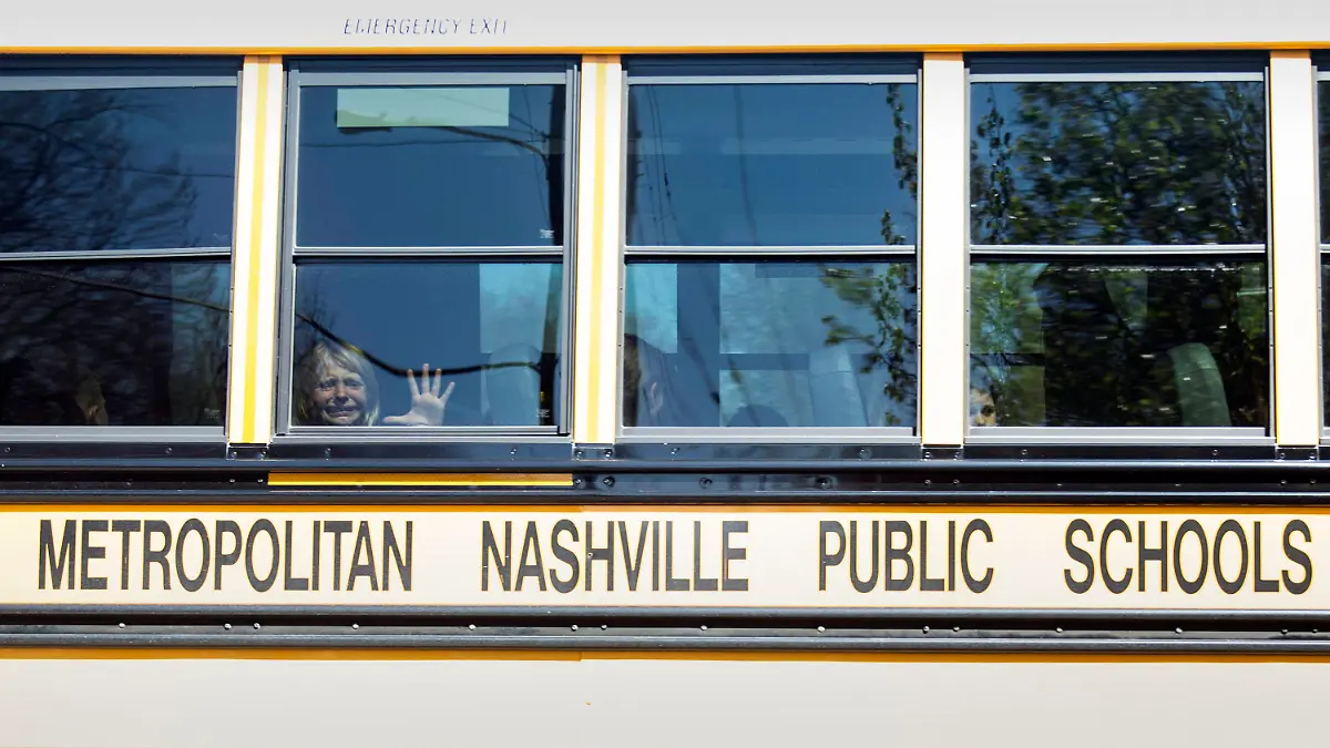 A child weeps while on the bus leaving The Covenant School following a mass shooting at the school in Nashville, Tenn., Monday, March 27, 2023. (Nicole Hester/The Tennessean via AP)