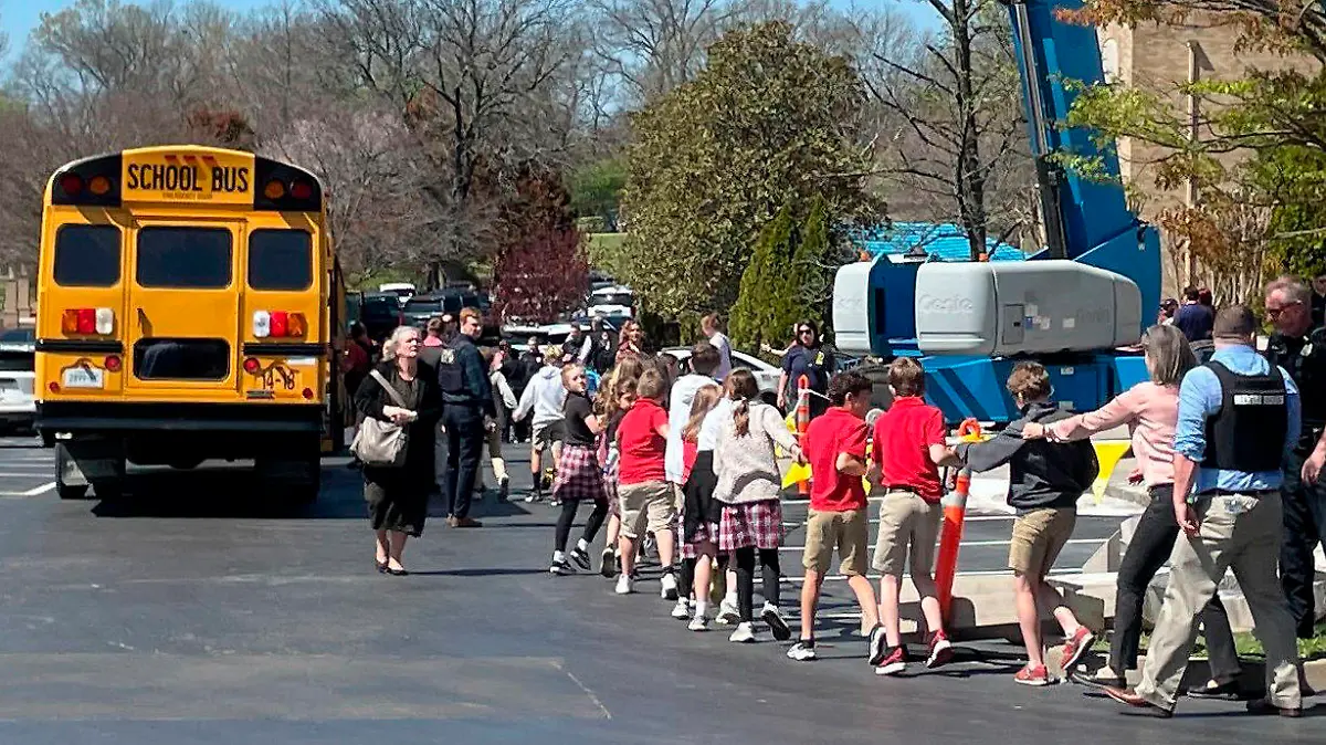 Children from The Covenant School, a private Christian school in Nashville, Tenn., hold hands as they are taken to a reunification site at the Woodmont Baptist Church after a shooting at their school, on Monday March, 27, 2023. (AP Photo/Jonathan Mattise)
