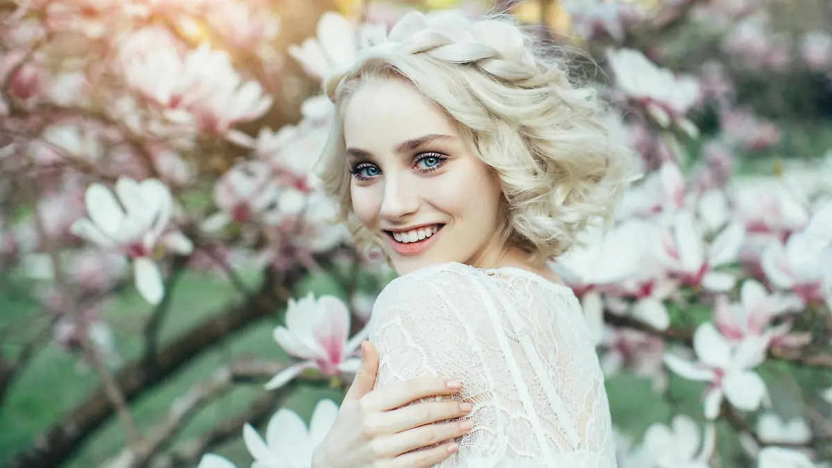Beautiful girl on the background of spring bush