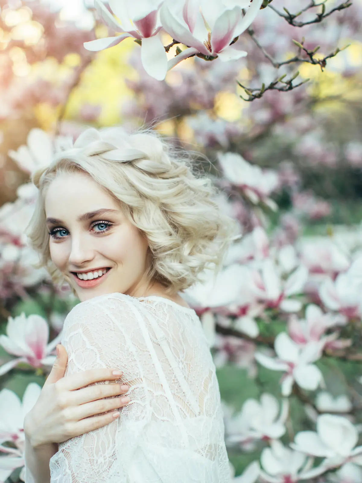 Beautiful girl on the background of spring bush
