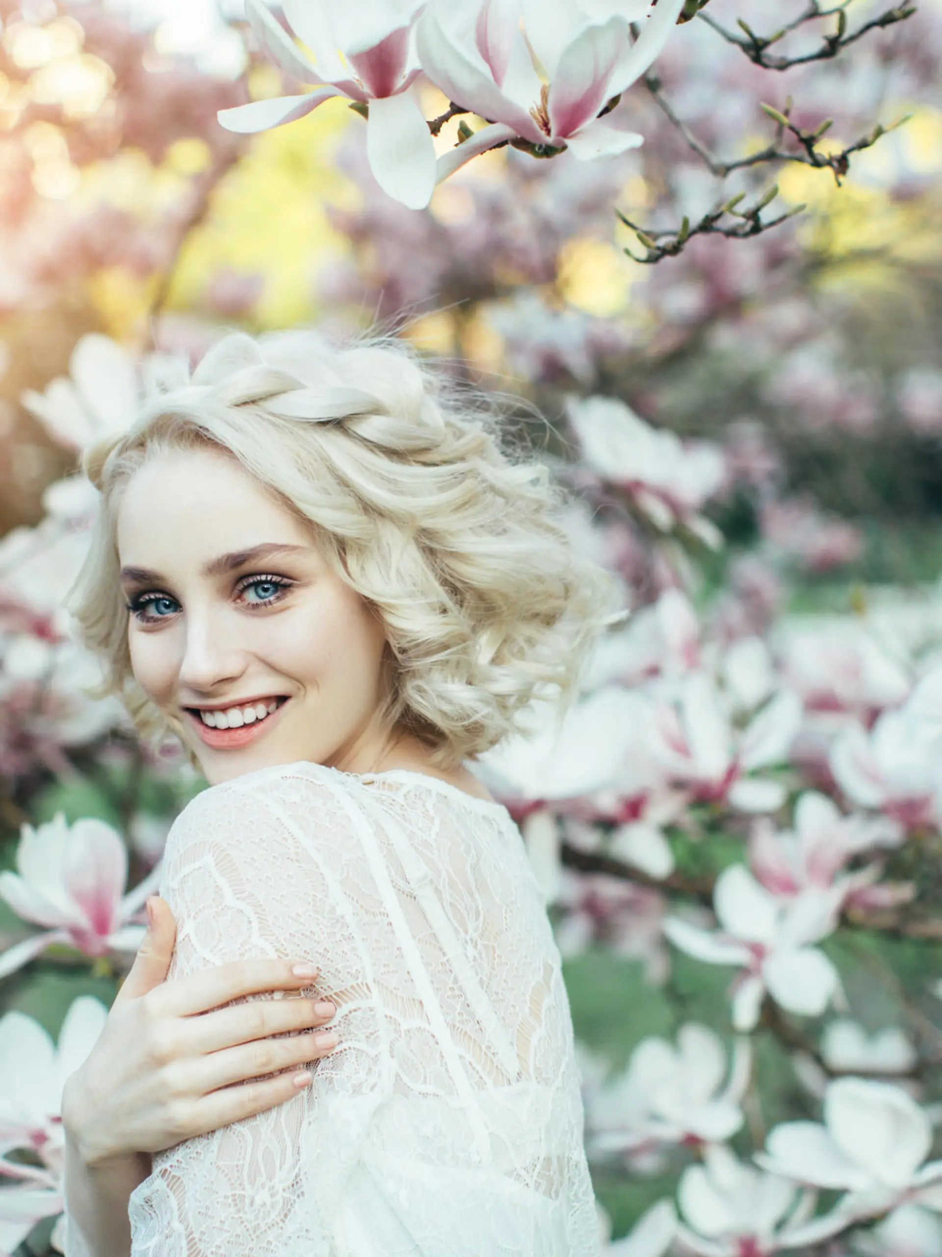 Beautiful girl on the background of spring bush