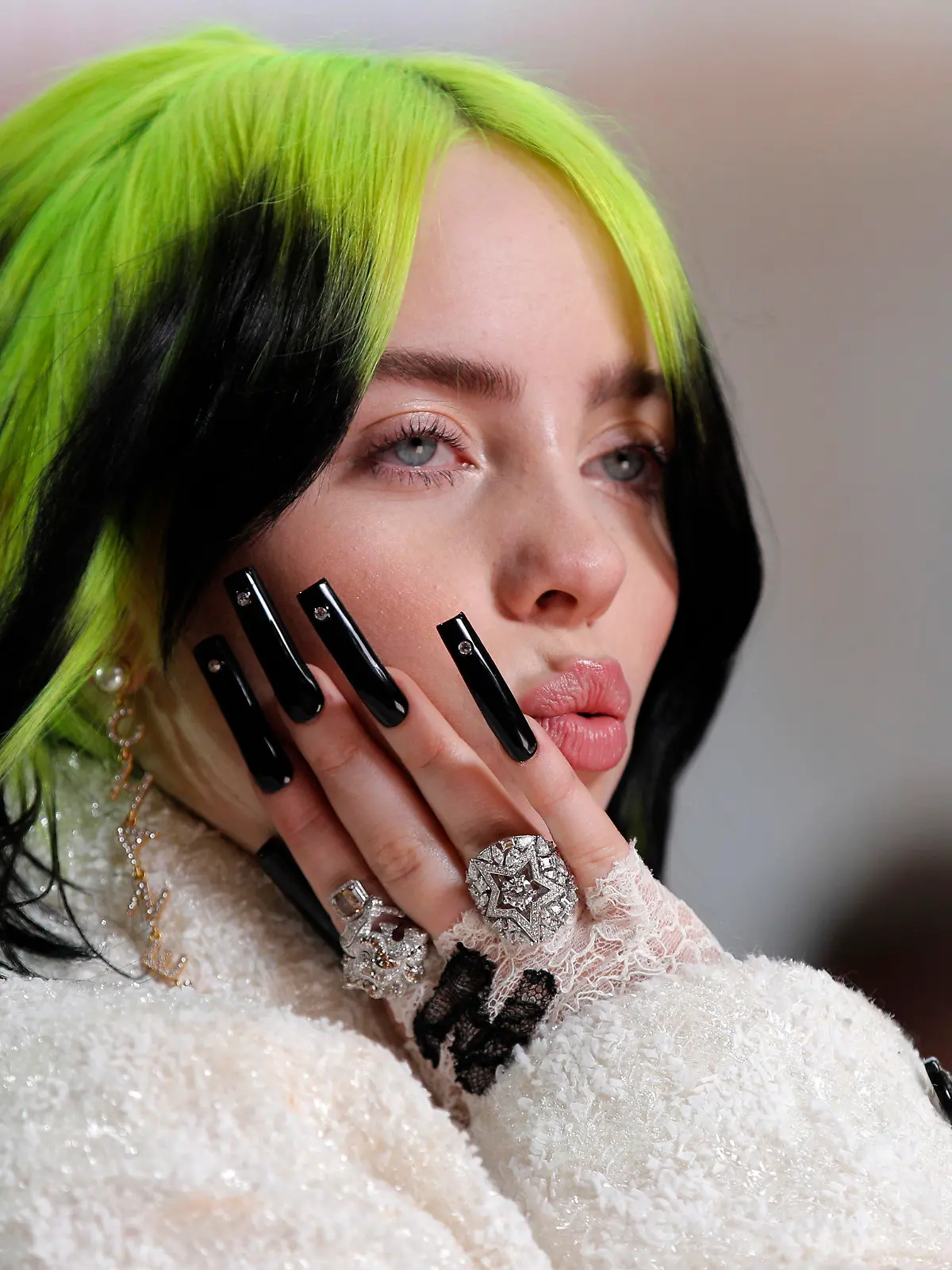 FILE - In this Feb. 9, 2020 file photo, singer Billie Eilish arrives at the Oscars in Los Angeles. The Elton John-led starry benefit concert that featured Eilish, Mariah Carey and Alicia Keys on Sunday has raised nearly $8 million to battle the coronavirus. The musicians performed from their homes for the hour-long event that aired on Fox and iHeartMedia radio stations. Fox will re-broadcast the concert on Monday, April 6. (AP Photo/John Locher, File)