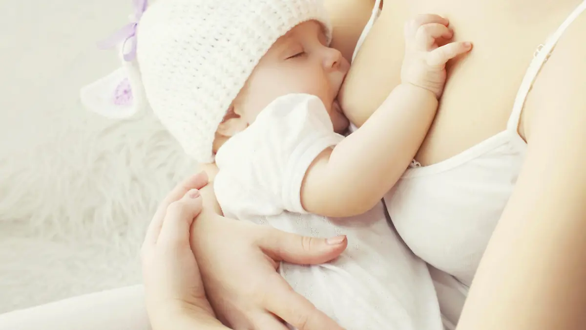 Soft photo mother feeding breast her baby at home