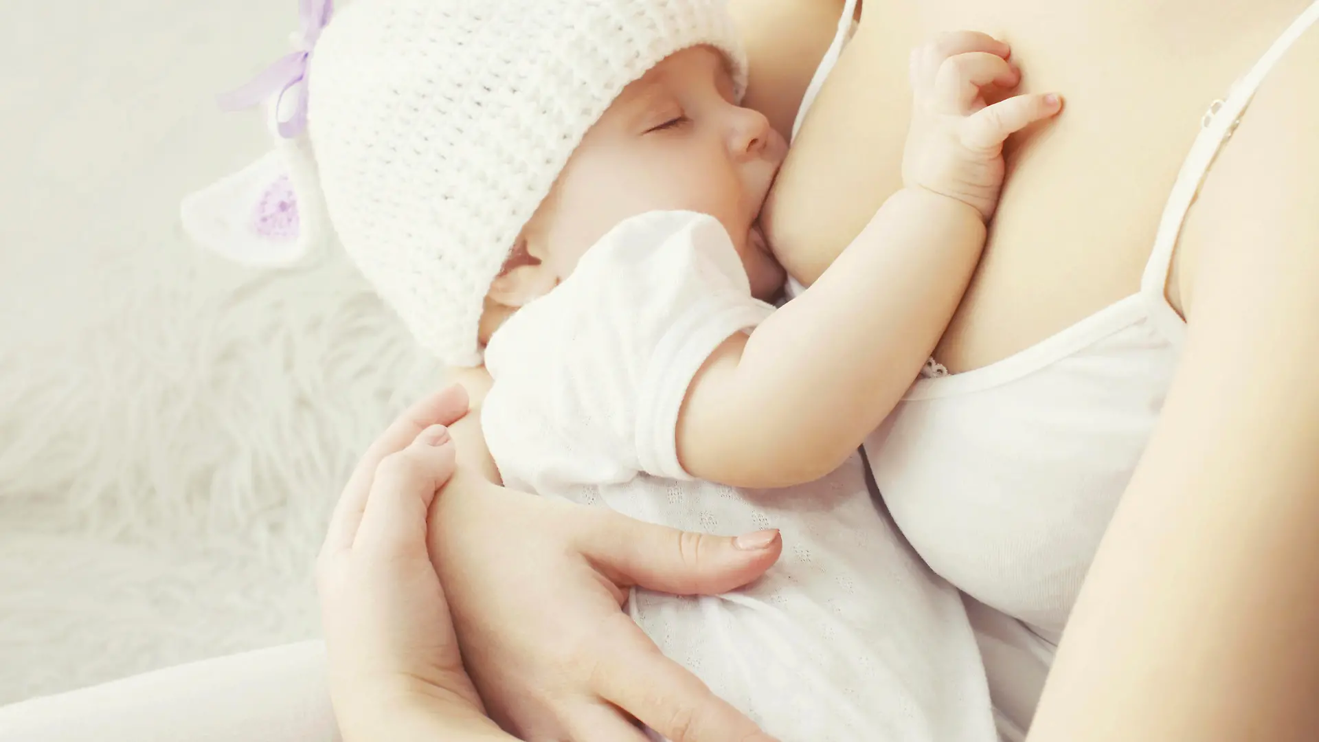 Soft photo mother feeding breast her baby at home