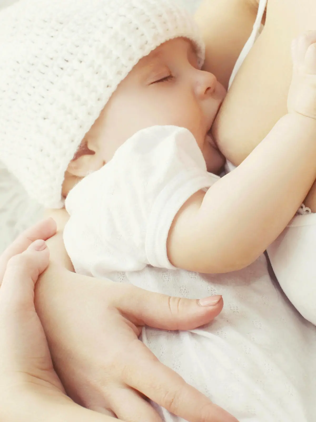 Soft photo mother feeding breast her baby at home 