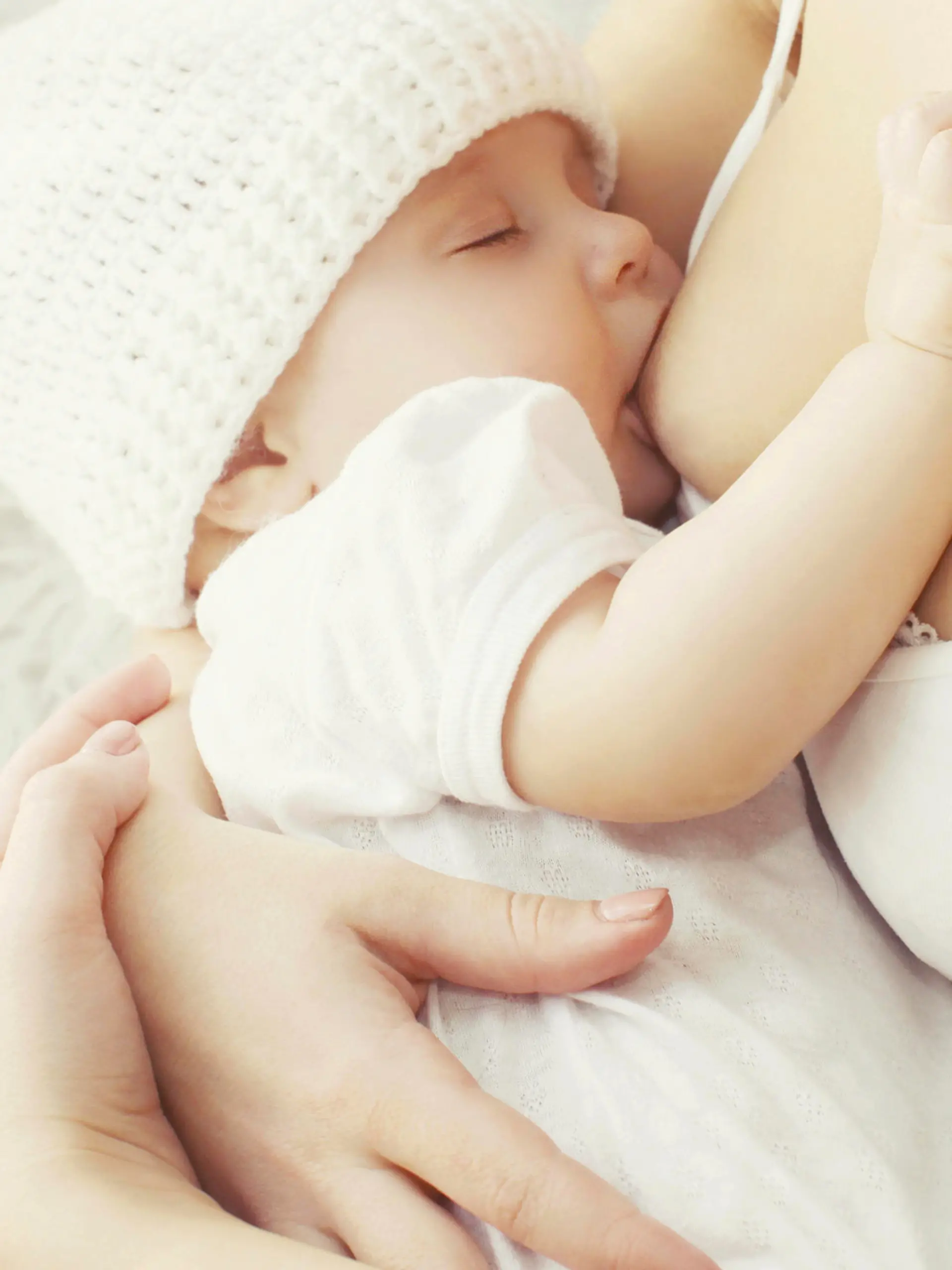 Soft photo mother feeding breast her baby at home 