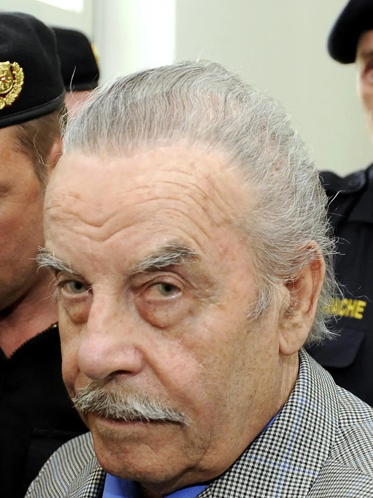 Defendant Josef Fritzl, center, is escorted to the fourth day of his trial in the provincial courthouse in St. Poelten, Austria, on Thursday, March 19, 2009. In a stunning turn of events the 73-year-old who fathered seven children with a daughter he held captive in a squalid cellar for 24 years, pleaded guilty on Wednesday to all charges against him after hearing his daughter's recorded testimony. The verdicts and sentences are expected Thursday afternoon. Fritzl faces up to life imprisonment. (AP Photo/Robert Jaeger, Pool) ** EDITORIAL USE ONLY **