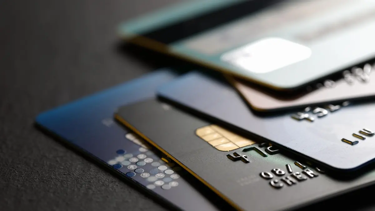 stack of multicolored credit cards on black background