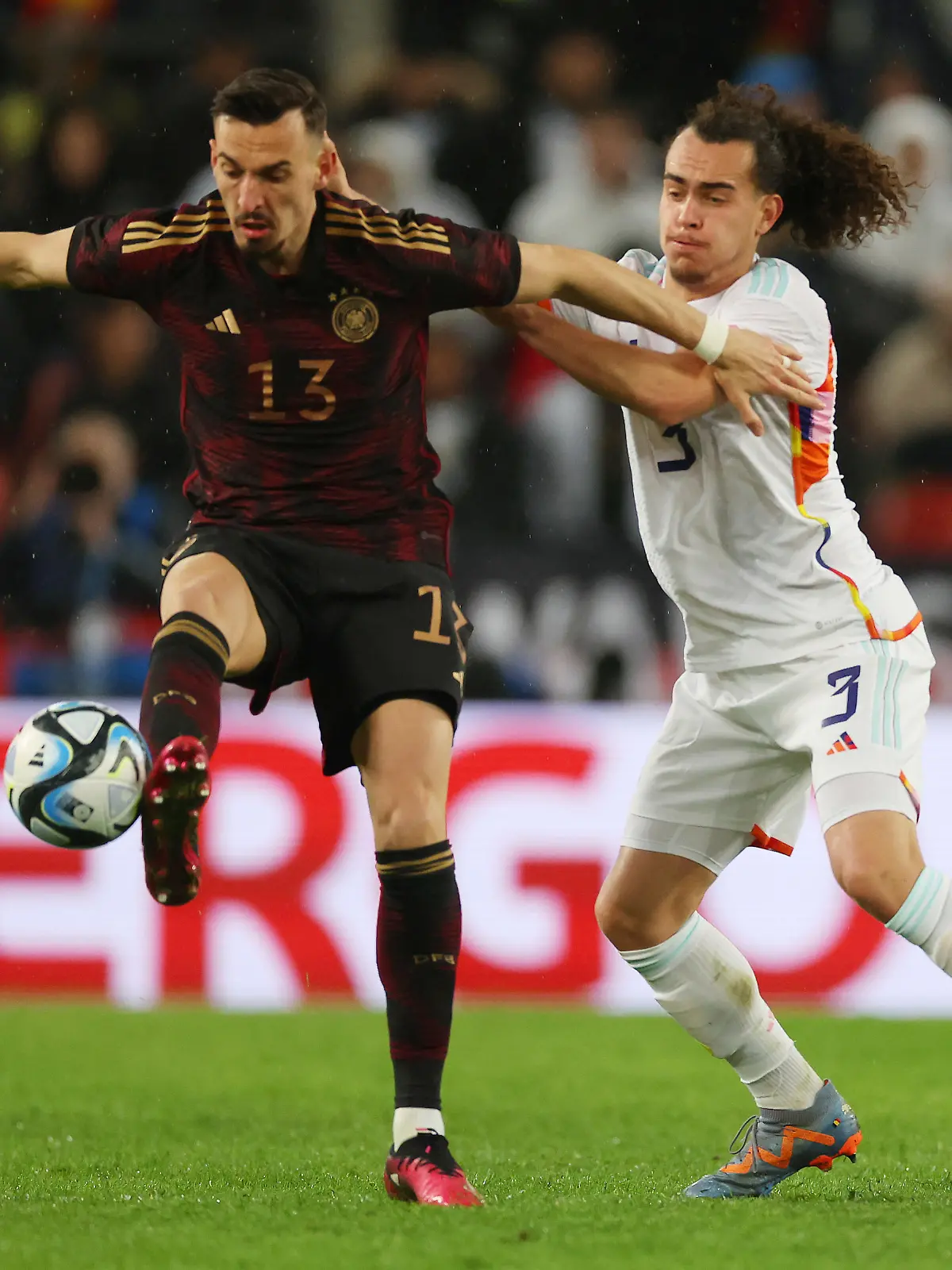 COLOGNE, GERMANY - MARCH 28: Mergim Berisha of Germany battles for possession with Arthur Theate of Belgium during the international friendly match between Germany and Belgium at RheinEnergieStadion on March 28, 2023 in Cologne, Germany. (Photo by Alexander Hassenstein/Getty Images)