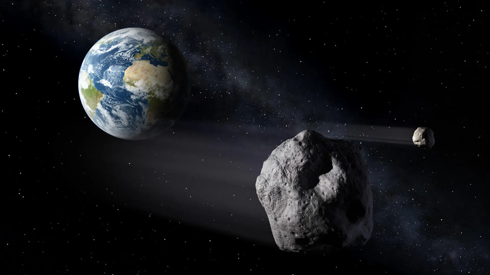 HANDOUT - Das Handout-Foto der European Space Agency (ESA) vom 07.02.2013 zeigt die im Rahmen der Mission Asteroid Impact simulierte Begegnung von Asteroiden mit der Erde. Zur Abwehr von Asteroiden auf Kollisionskurs mit der Erde plant die Europäische Weltraumorganisation Esa die Asteroid Impact Mission (AIM). Von Oktober 2020 an soll eine Sonde zu den Didymos-Zwillings-Asteroiden fliegen. Die beiden Kleinplaneten kommen zwei Jahre später bis auf elf Millionen Kilometer an die Erde heran, laut Esa «vergleichsweise nahe». Foto: ESA Science Office/dpa ACHTUNG: Das Foto darf nur redaktionell bei Nennung der Quelle «ESA Science Office» im Zusammenhang mit dem genannten dpa-Text verwendet werden! (zu dpa «Einschlag auf «Didymoon» soll Abwehr von Asteroiden testen» vom 10.04.2015) |