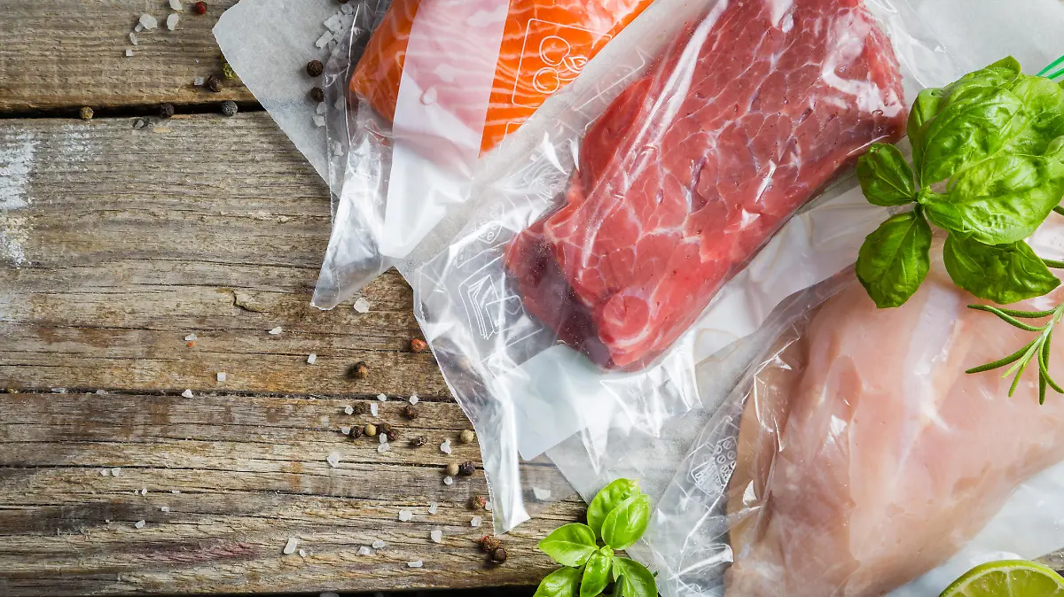 Beef, chicken and salmon in vacuum plastic bag for sous vide cooking, copy space