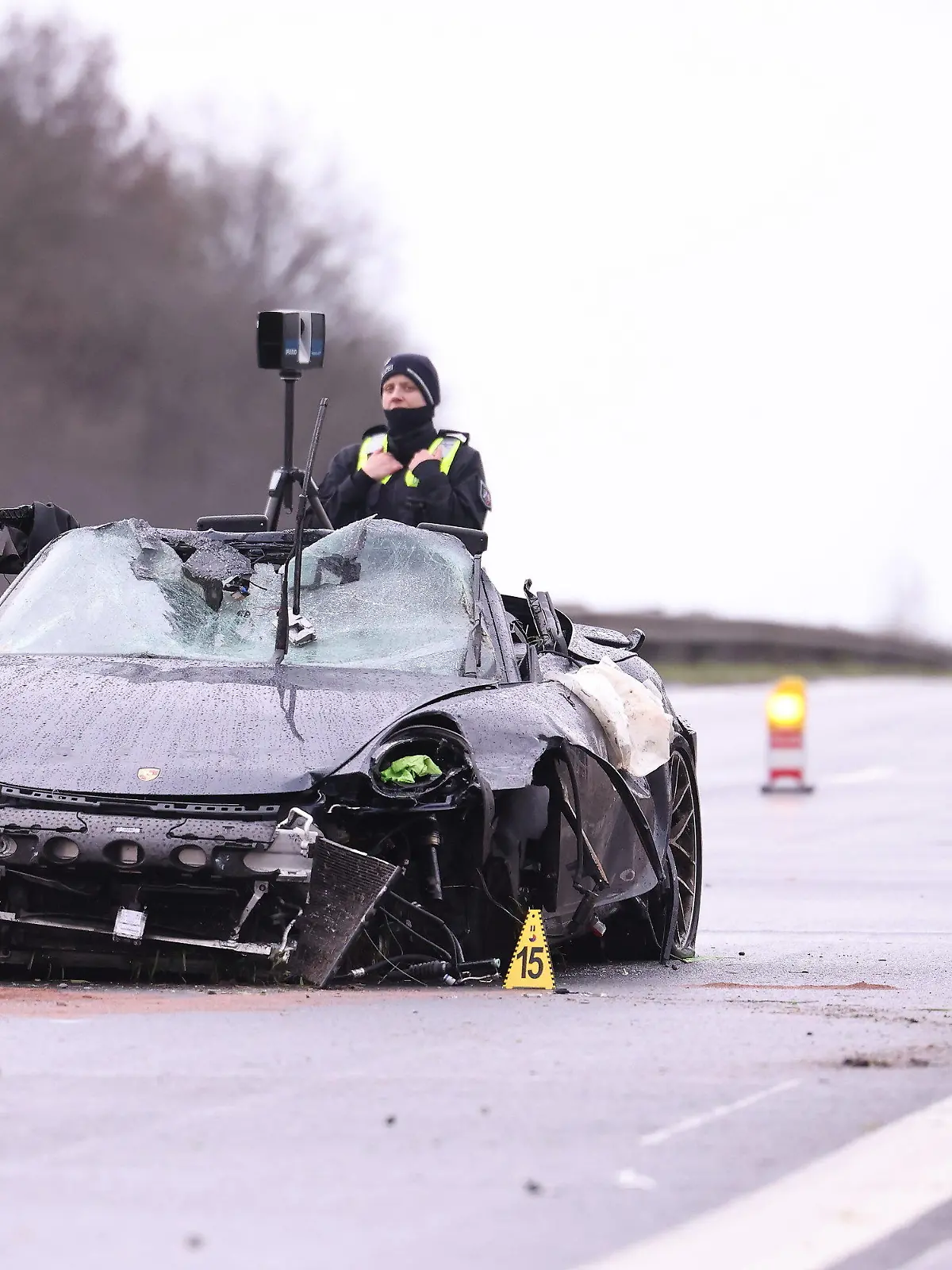 26.03.2023, Nordrhein-Westfalen, Emmerich: Polizisten untersuchen mit einem 3D-Scanner neben einem demolierten Porsche einen Unfallort auf der A3 bei Emmerich. Vier Menschen sind bei kurz aufeinander folgenden Unfällen auf der A3 bei Emmerich am Niederrhein ums Leben gekommen - darunter auch ein Ersthelfer. Rettungshubschrauber, Notärzte und Krankenwagen waren den Angaben zufolge im Einsatz. Der Autobahnabschnitt Richtung Köln wurde voll gesperrt. Drei an den Unfällen beteiligte Fahrzeuge hatten niederländische Zulassungen. Foto: David Young/dpa +++ dpa-Bildfunk +++