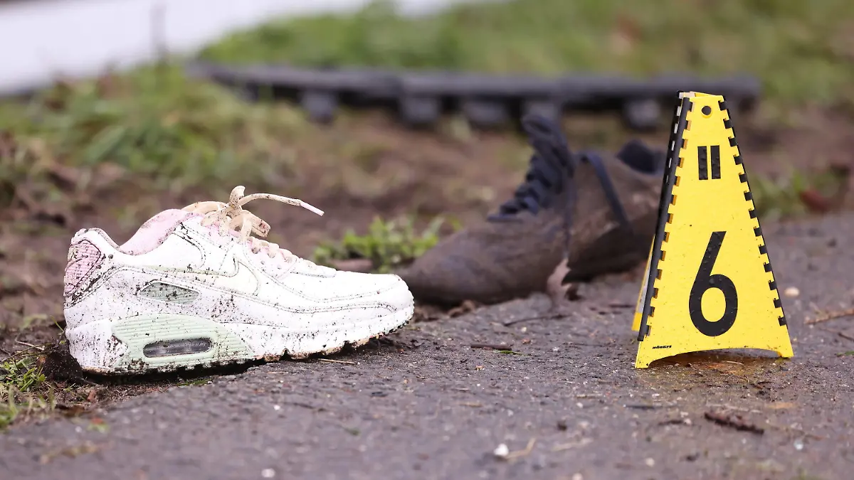 26.03.2023, Nordrhein-Westfalen, Emmerich: Sportschuhe liegen auf dem Seitenstreifen neben der A3 bei Emmerich. Vier Menschen sind bei kurz aufeinander folgenden Unfällen auf der A3 bei Emmerich am Niederrhein ums Leben gekommen - darunter auch ein Ersthelfer. Rettungshubschrauber, Notärzte und Krankenwagen waren den Angaben zufolge im Einsatz. Der Autobahnabschnitt Richtung Köln wurde voll gesperrt. Drei an den Unfällen beteiligte Fahrzeuge hatten niederländische Zulassungen. Foto: David Young/dpa +++ dpa-Bildfunk +++