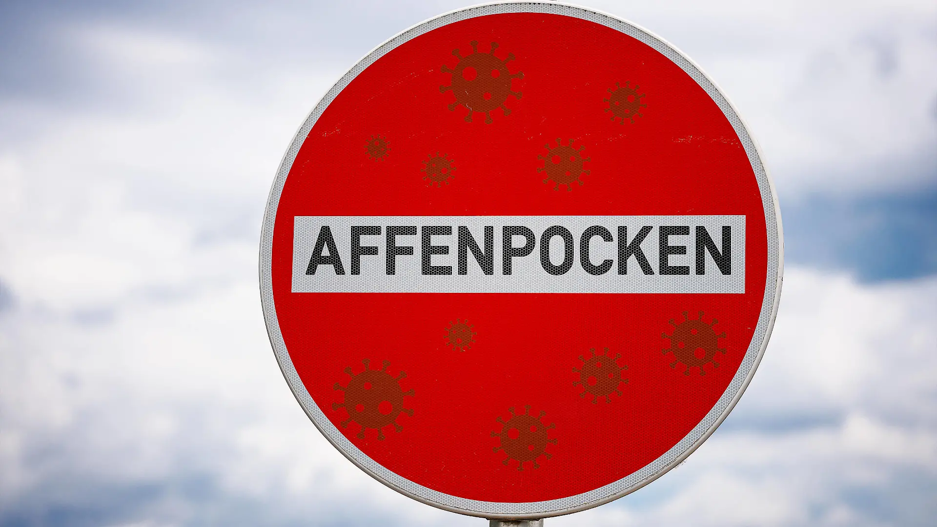 20 June 2022: red sign with the inscription monkeypox PHOTOMONTAGE *** rotes Schild mit der Aufschrift Affenpocken FOTOMONTAGE