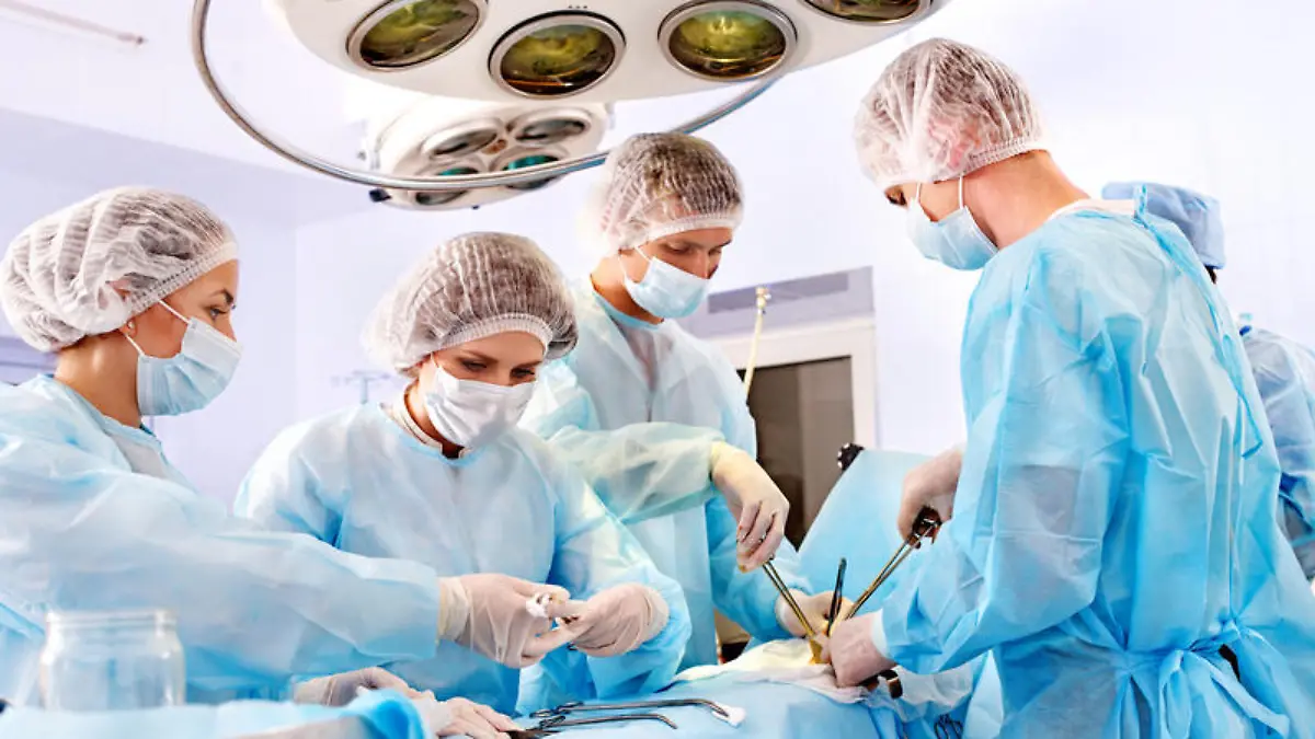 Team surgeon at work in operating room.