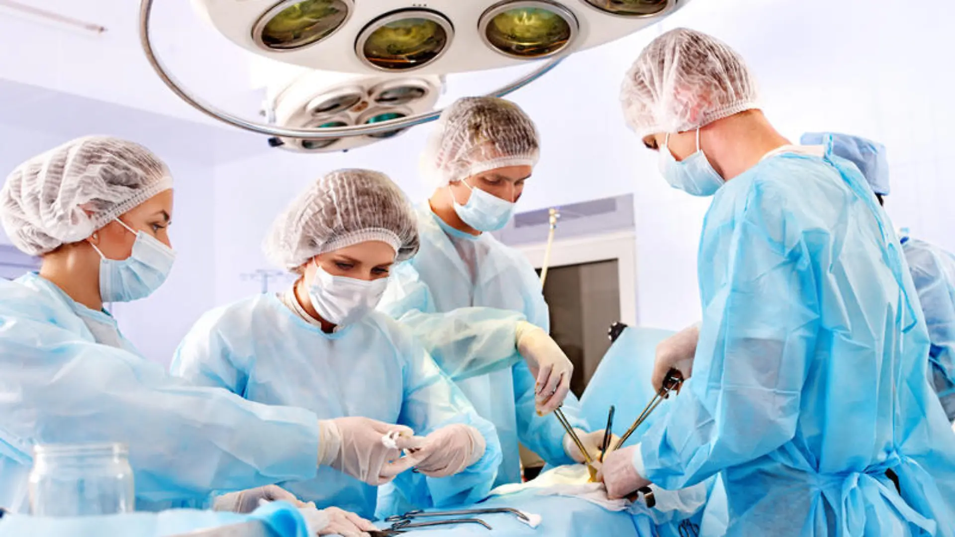 Team surgeon at work in operating room.