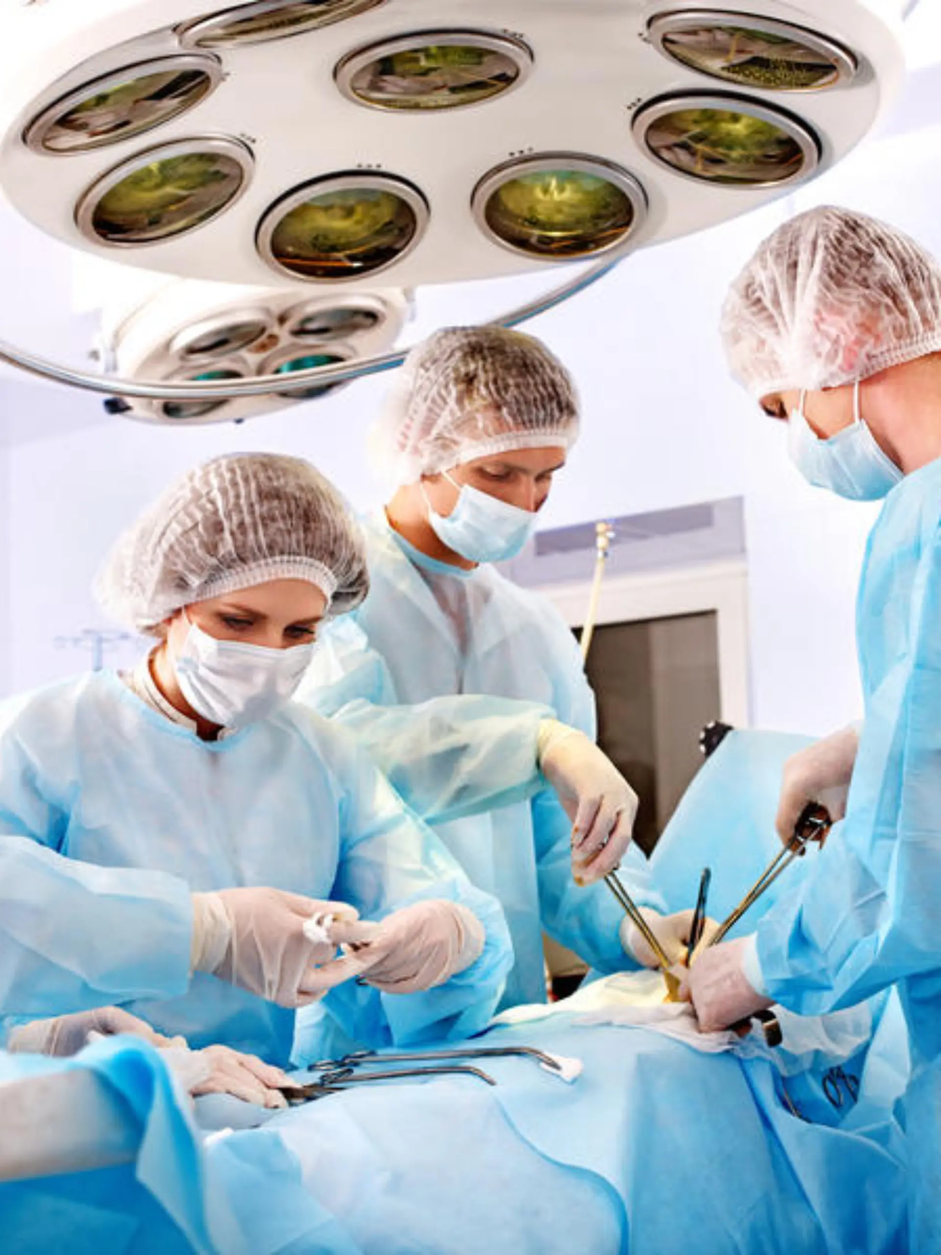 Team surgeon at work in operating room.