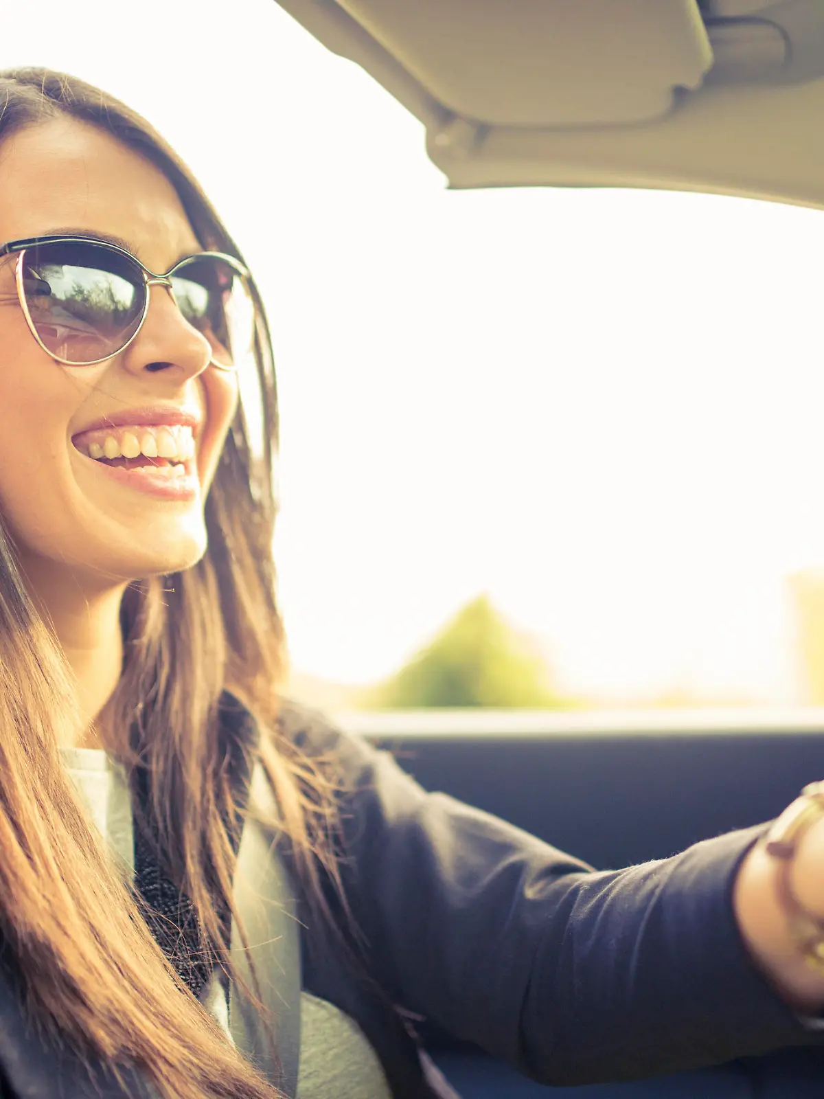 Beautiful girl in cabriolet car, sunny day at the city