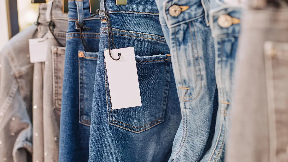 sale assortment denim collection on the stand in a stylish boutique shop selection
