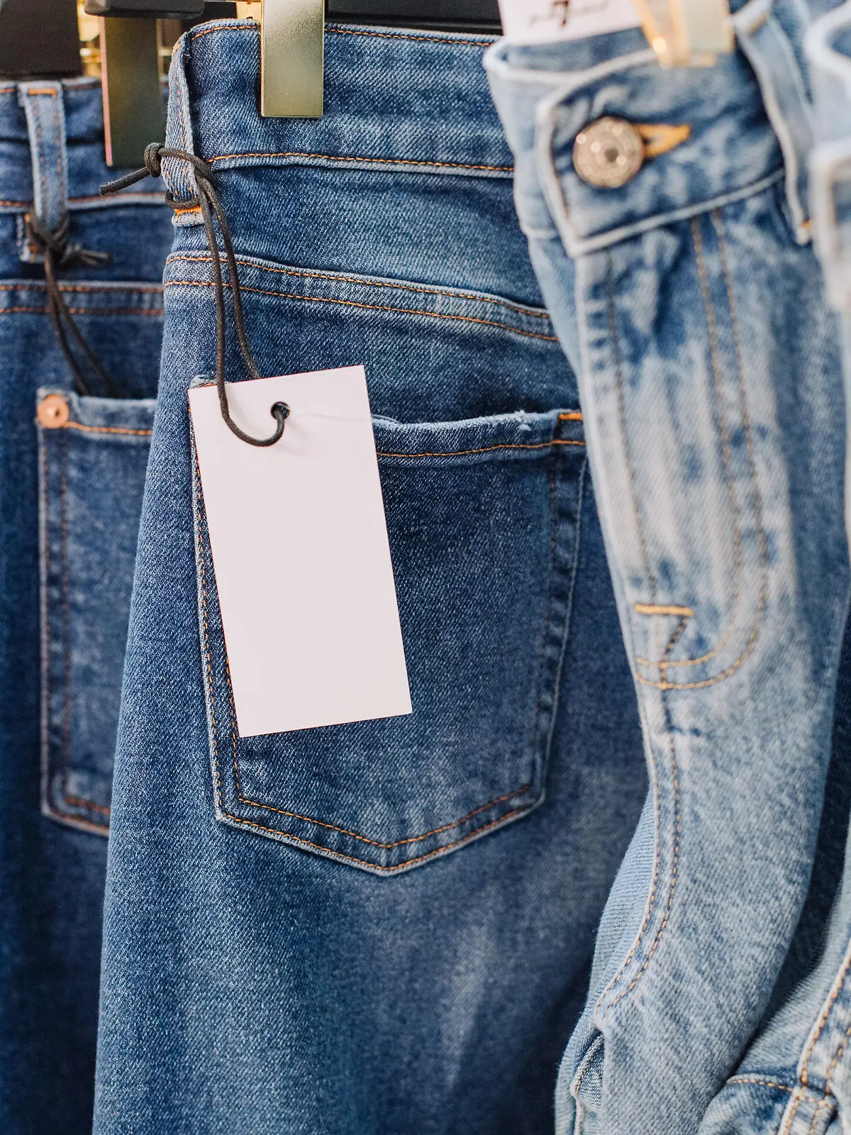 sale assortment denim collection on the stand in a stylish boutique shop selection