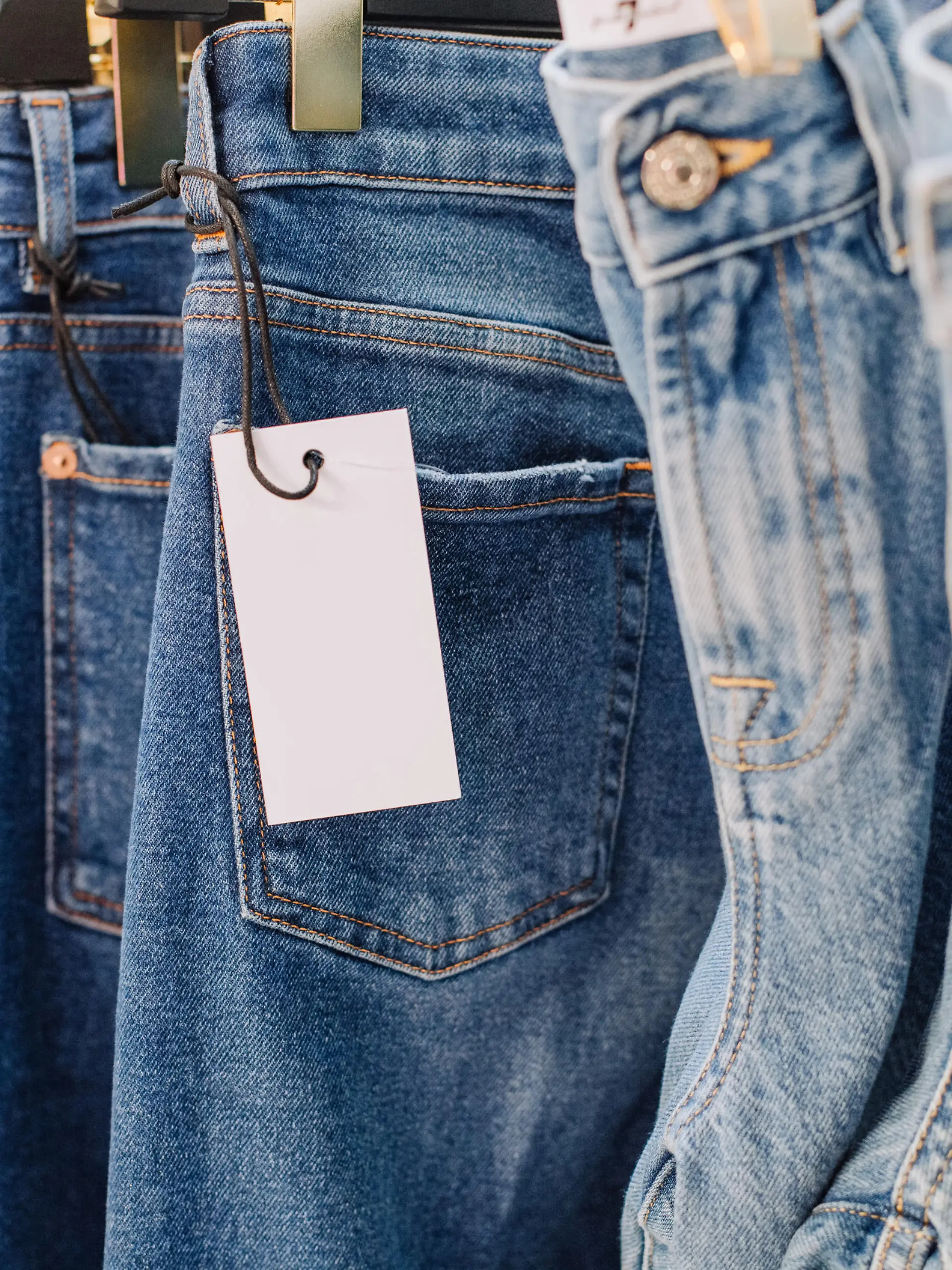 sale assortment denim collection on the stand in a stylish boutique shop selection