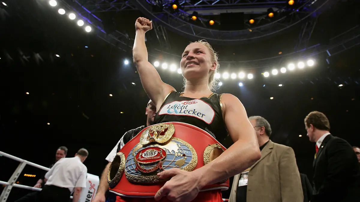 KARLSRUHE, GERMANY - NOVEMBER 30: Regina Halmich of Germany celebrates after beating Hagar Shmoulefeld Finer of Israel in defense of her WIBF World Championship flyweight title at the DM Arena on November 30, 2007 in Karlsruhe, Germany. Halmich has said she will retire after 13-years of professional boxing and 12-years as the unbeaten world champion. (Photo by Vladimir Rys/Bongarts/Getty Images)