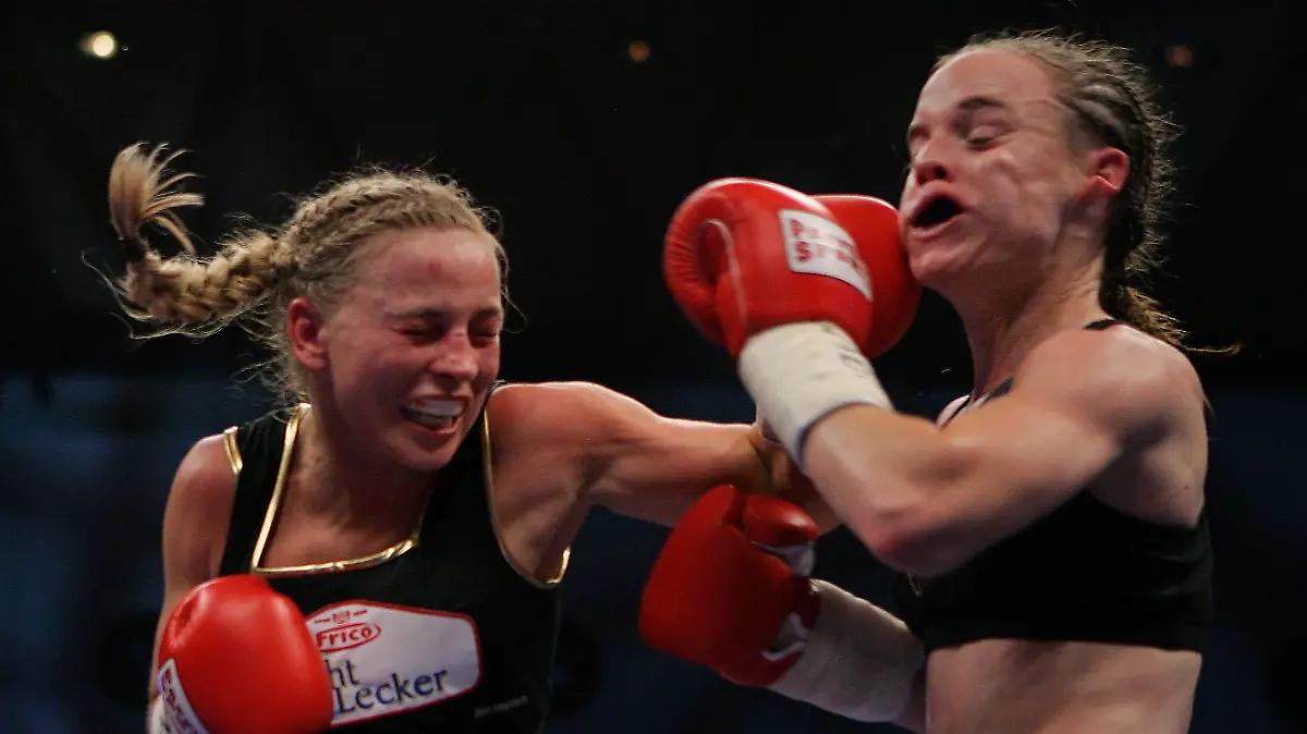 KARLSRUHE, GERMANY - NOVEMBER 30: Regina Halmich of Germany (L) lands a punch against Hagar Shmoulefeld Finer of Israel during their WIBF World Championship flyweight title fight at the DM Arena on November 30, 2007 in Karlsruhe, Germany. Halmich, who won the fight, has said she will retire after 13 years of professional boxing and 12 years as the unbeaten world champion. (Photo by Vladimir Rys/Bongarts/Getty Images)