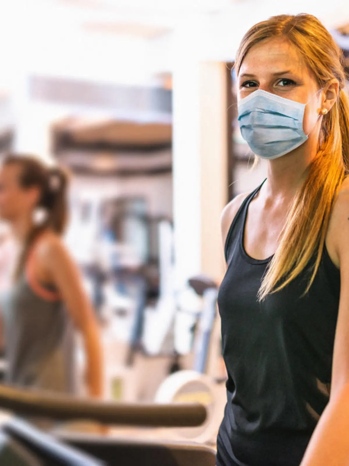 Frau im Fitnessstudio während der Corona-Pandemie