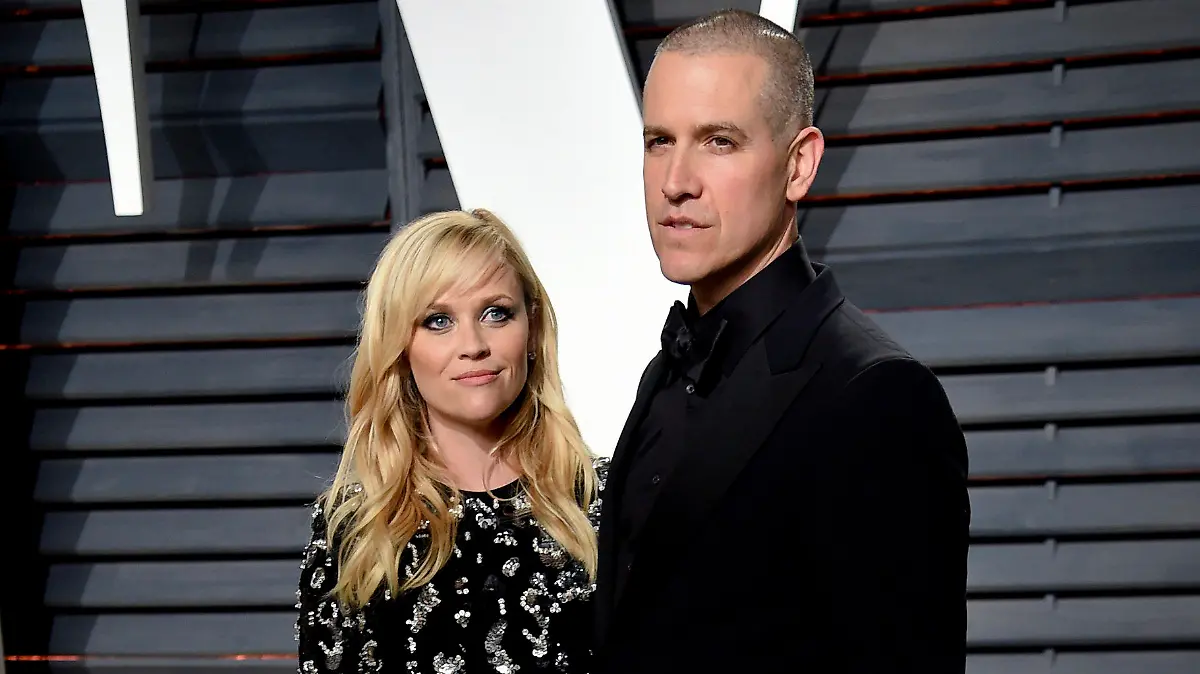 FILE - Reese Witherspoon and Jim Toth appear at the Vanity Fair Oscar Party in Beverly Hills, Calif. on Feb. 27, 2017.  Witherspoon and her husband, Hollywood agent Jim Toth, have announced they are divorcing after nearly 12 years of marriage. (Photo by Evan Agostini/Invision/AP, File)
