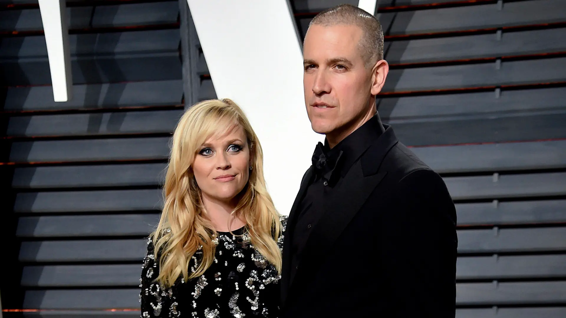 FILE - Reese Witherspoon and Jim Toth appear at the Vanity Fair Oscar Party in Beverly Hills, Calif. on Feb. 27, 2017. Witherspoon and her husband, Hollywood agent Jim Toth, have announced they are divorcing after nearly 12 years of marriage. (Photo by Evan Agostini/Invision/AP, File)