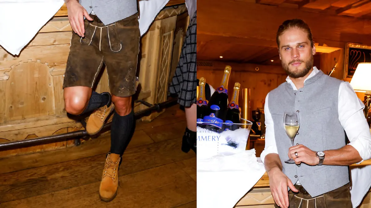 Rúrik Gíslason hält ein Glas Champagner in der Hand. Der ehemalige Fußballer ist Gast bei den Spa Awards 2023 im Hotel Stanglwirt in Kitzbühel und trägt standesgemäß Lederhosen.