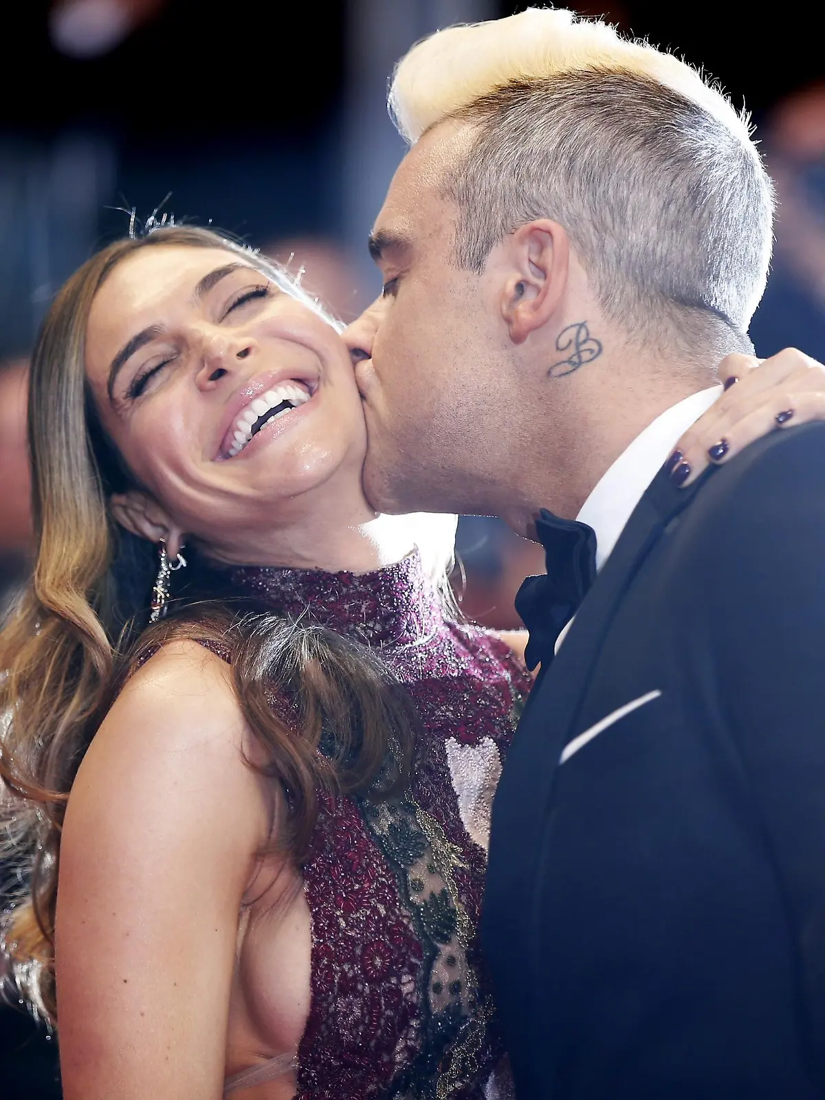 British singer Robbie Williams (R) kisses his wife Ayda Field as they arrive for the screening of the film 'The Sea of Trees' at the 68th Cannes Film Festival in Cannes, southeastern France, on May 16, 2015.   AFP PHOTO / VALERY HACHE        (Photo credit should read VALERY HACHE/AFP/Getty Images)