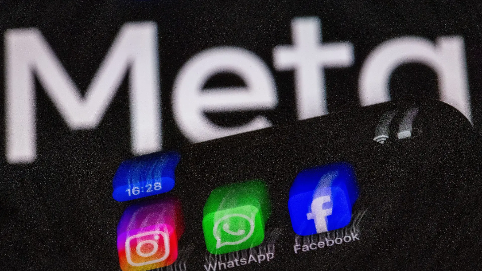 Die Apps Instagram, Facebook und WhatsApp sind auf dem Display eines Smartphones vor dem Logo des Internetkonzerns Meta zu sehen. Meta kann ab sofort in großem Stil damit beginnen, seine Systeme mit Künstlicher Intelligenz mit Nutzerdaten aus Deutschland zu trainieren.