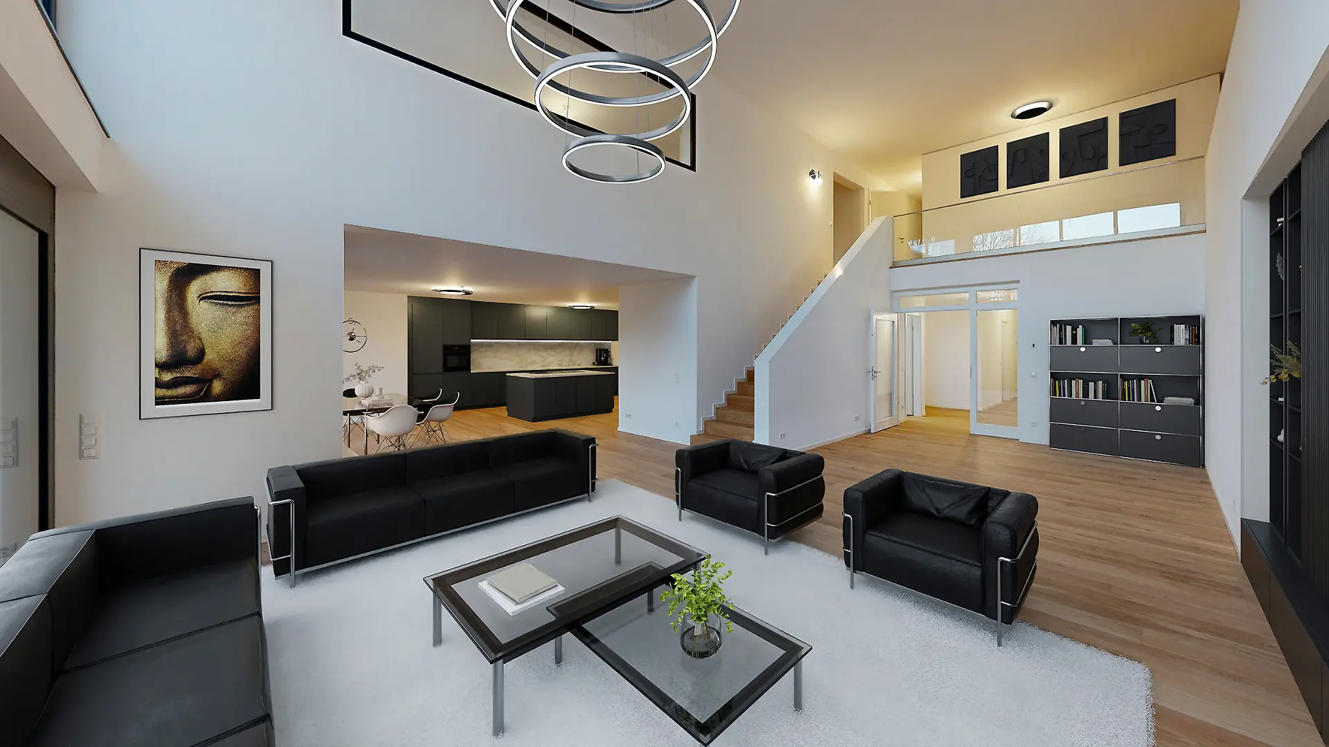 Wohnungsbereich einer der Wohnungen mit schwarzen Polstermöbeln und Glastischen auf Laminat, dazu ein weißer Teppich und ein Küchenbereich im Hintergrund.