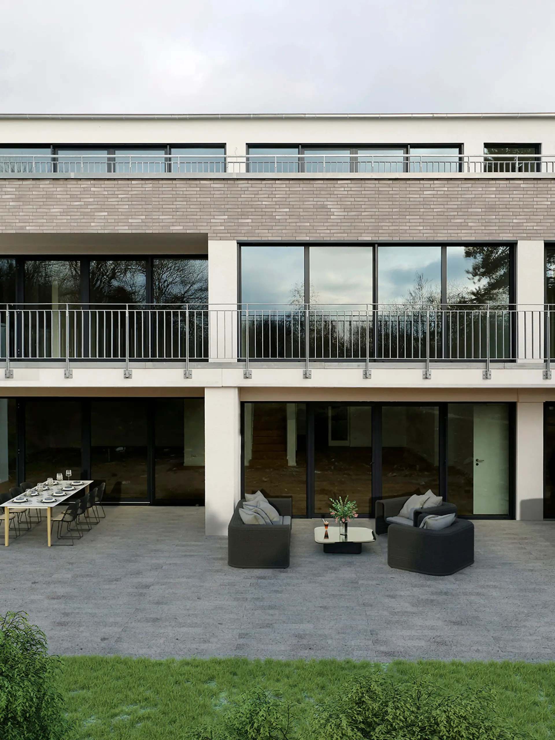 Grau-weiße Villa in der Frontalansicht von außen. Auf der Terrasse befindet sich ein kleiner Essbereich, eine Sitzecke sowie ein Whirlpool.