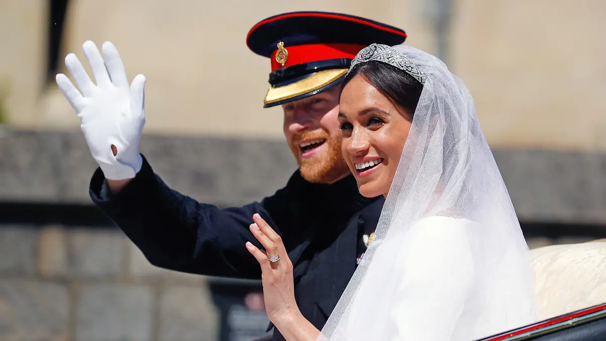 ARCHIV - 19.05.2018, Großbritannien, Windsor: Prinz Harry und seine Frau Meghan fahren nach der Trauung in der Pferdekutsche "Ascot Landau" und winken. (zu dpa: Harry, Meghan und die Öffentlichkeit: Geschichte einer Entfremdung) Foto: Phil Noble/AP/dpa +++ dpa-Bildfunk +++