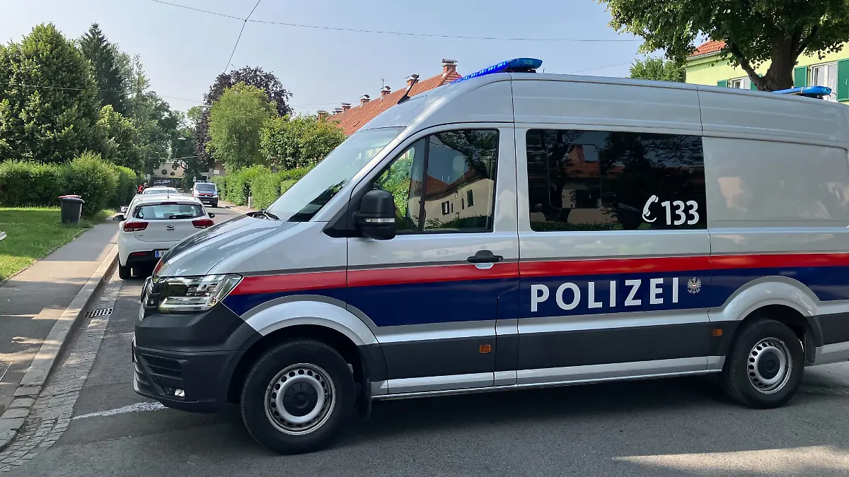 Ein Polizeiwagen blockiert eine Straße. Die Polizei in Graz (Österreich) hat die Zufahrt zu einem Kindergarten abgesperrt. Dort wurde ein verdächtiger Gegenstand gefunden.