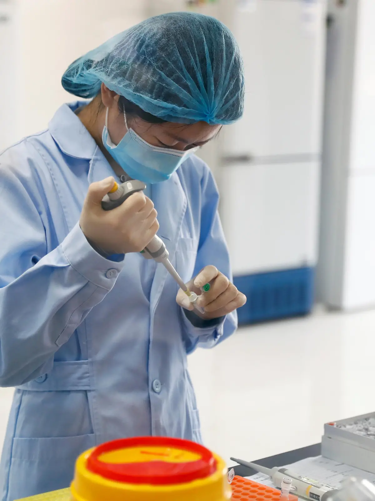 An employee works at the R&D laboratory of the Beijing Applied Biological Technologies Co. during a government organised tour of the facility following the outbreak of the new coronavirus disease (COVID-19), in Beijing, China, May 14, 2020. REUTERS/Thomas Peter