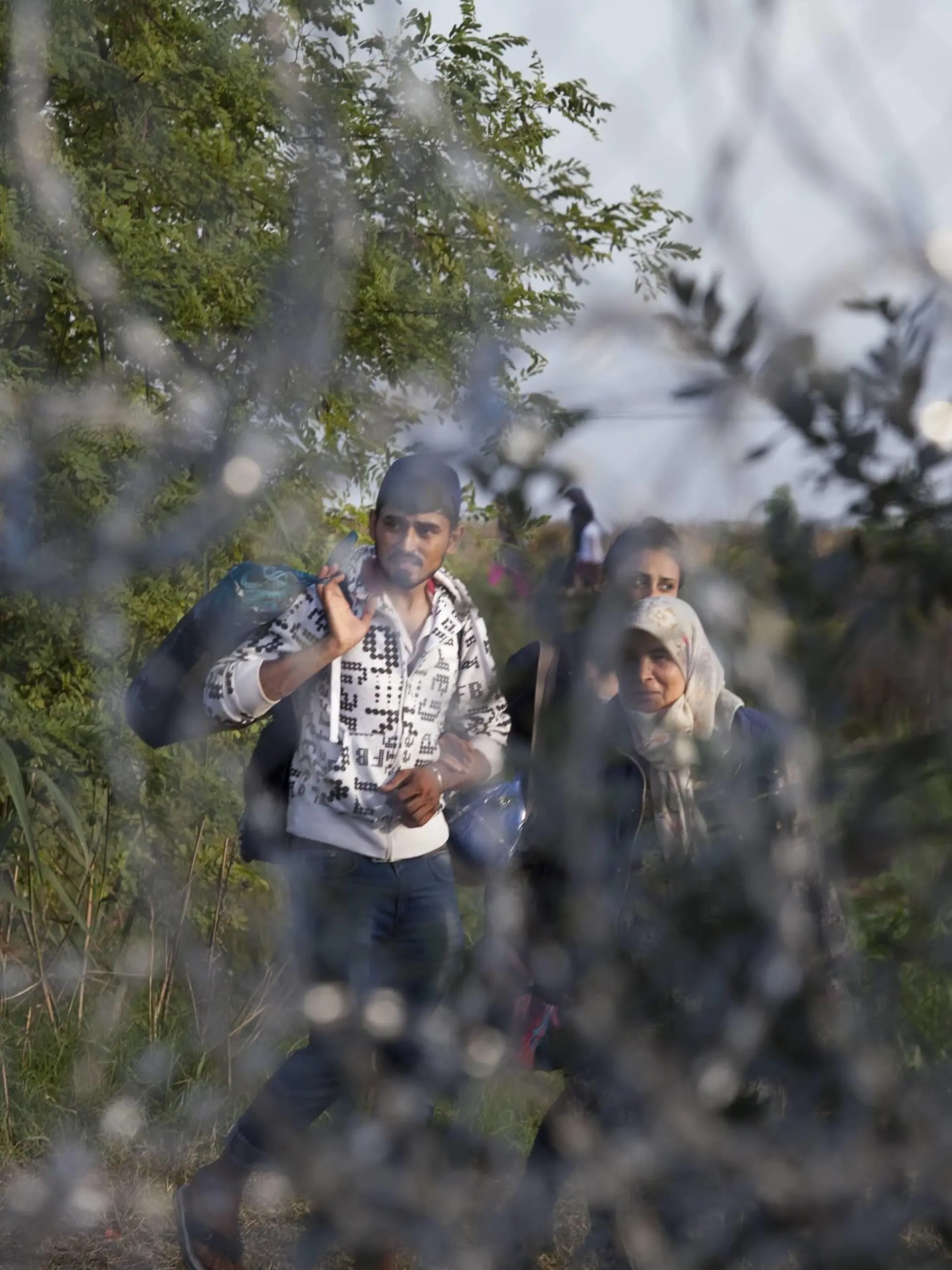Sept. 14, 2015 - Roszke - Roszke, Hungary- September 14, 2015-- Immigrants were kept behind a barbed wire fence as Hungary began closing it s southern border on Monday They were funneled towards a formal checkpoint where numerous people were detained and put on buses at the Roszke border crossing. Roszke PUBLICATIONxINxGERxSUIxAUTxONLY - ZUMAn230
