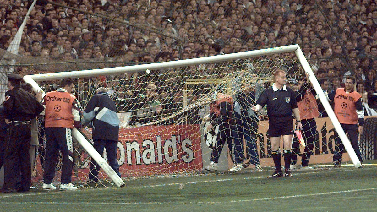 ARCHIV - Ein Linienrichter geht am 01.04.1998 im Stadion Santiago Bernabeu in Madrid von dem umgestürzten Tor weg. Vor dem Champions-League-Halbfinale zwischen Real Madrid und Borussia Dortmund hatten Fans den Zaun hinter dem Tor eingerissen. Der daran befestigte Kasten und das Tor stürzten um. Foto: dpa (zu dpa 0834 vom 05.11.2012) +++(c) dpa - Bildfunk+++