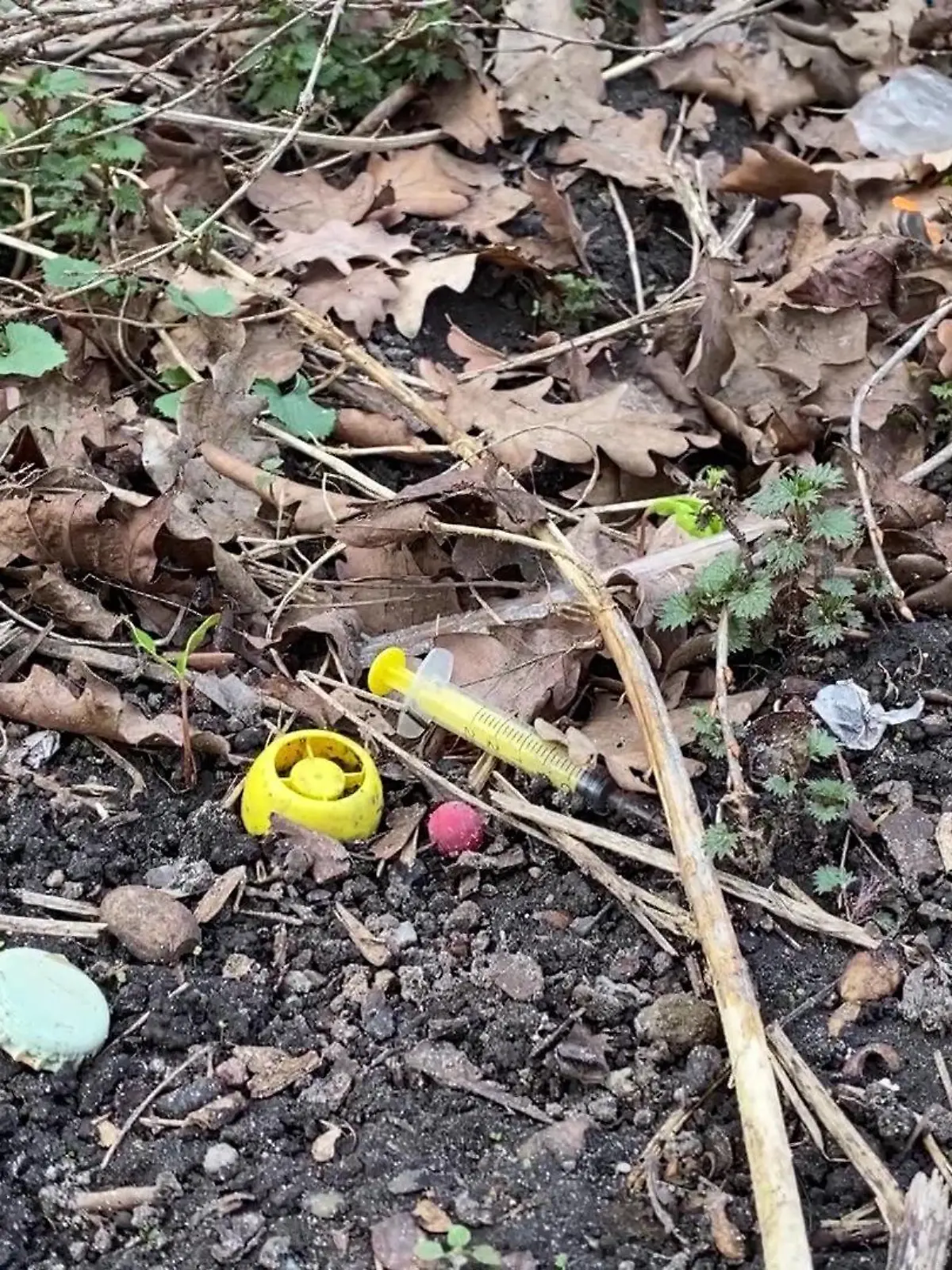 Eine benutzte Spritze liegt am Leopoldplatz in Berlin direkt neben einem Spielplatz.