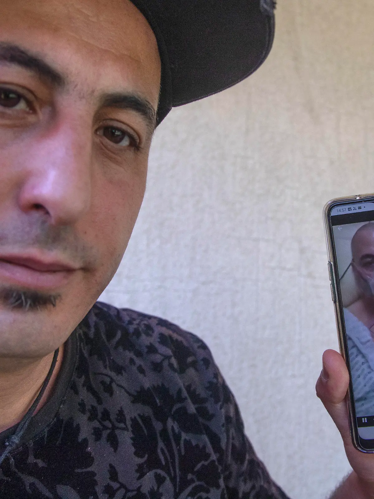 Amirouche Hammar show his picture taken at the hospital on his mobile phone during an interview with The Associated-Press in Bobiny, east of Paris, Wednesday, May 6, 2020. In a study published in the International Journal of Microbial Agents, doctors at a hospital north of Paris reviewed retrospective samples of 14 patients treated for atypical pneumonia between early December and mid-January. Among those were the records of Amirouche Hammar, a 42-year-old fishmonger from Algeria who has lived in France for years and had no recent travel history. (AP Photo/Michel Euler)