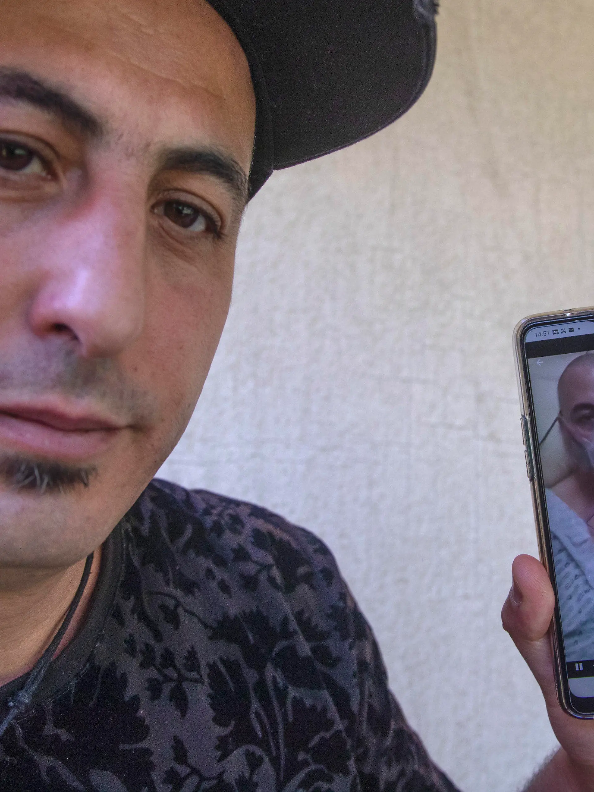 Amirouche Hammar show his picture taken at the hospital on his mobile phone during an interview with The Associated-Press in Bobiny, east of Paris, Wednesday, May 6, 2020. In a study published in the International Journal of Microbial Agents, doctors at a hospital north of Paris reviewed retrospective samples of 14 patients treated for atypical pneumonia between early December and mid-January. Among those were the records of Amirouche Hammar, a 42-year-old fishmonger from Algeria who has lived in France for years and had no recent travel history. (AP Photo/Michel Euler)