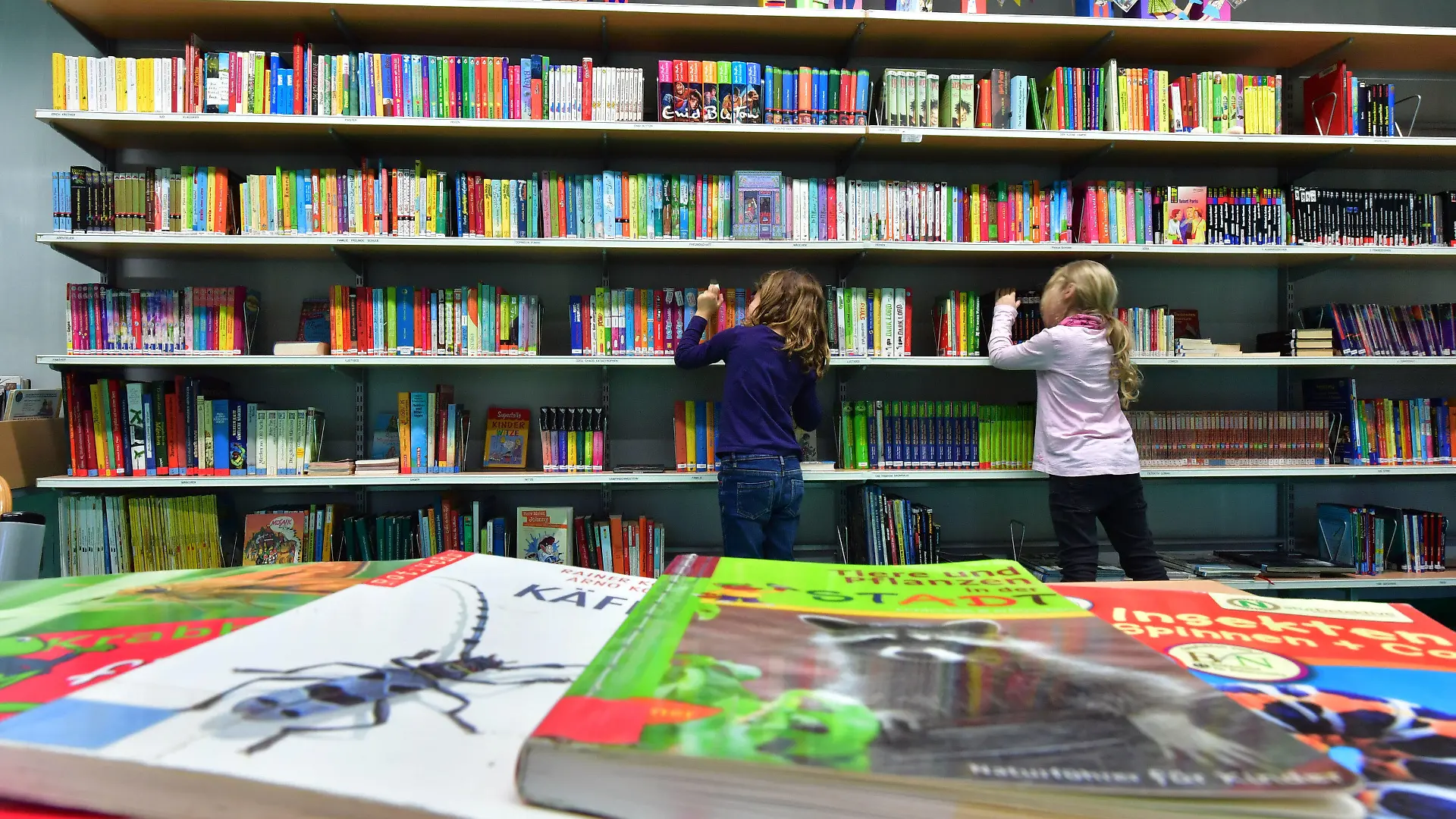 ARCHIV - 20.10.2016, Thüringen, Erfurt: In der Bibliothek Südpark suchen sich Kinder Bücher aus. Mit einer neuen Verordnung lockert Thüringen nach und nach etliche Verbote zur Eindämmung der Corona-Pandemie. Bibliotheken können schon ab dem 20.04.2020 wieder öffnen. (zu dpa "Lockerungen in der Corona-Krise - Bibliotheken dürfen öffnen") Foto: Martin Schutt/dpa-Zentralbild/dpa +++ dpa-Bildfunk +++