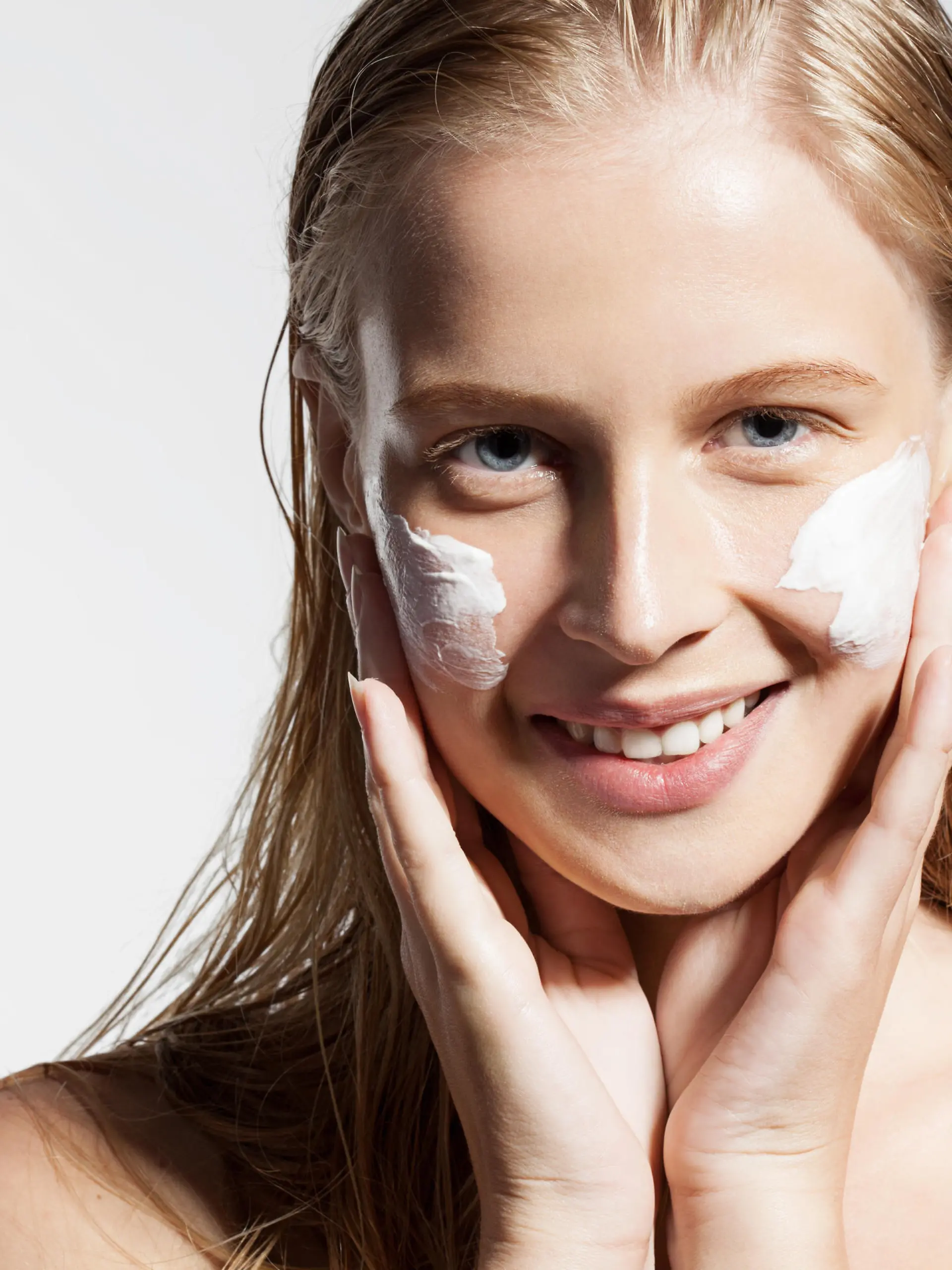 Close-up of a girl put the cream on the face