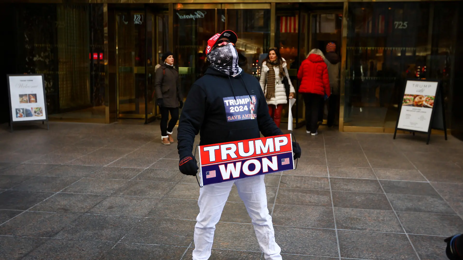 A man who identified himself as Don Cini, a supporter of former U.S. President Donald Trump, holds a Trump campaign sign outside Trump Tower in midtown Manhattan in New York City, New York, U.S., March 20, 2023. REUTERS/Mike Segar