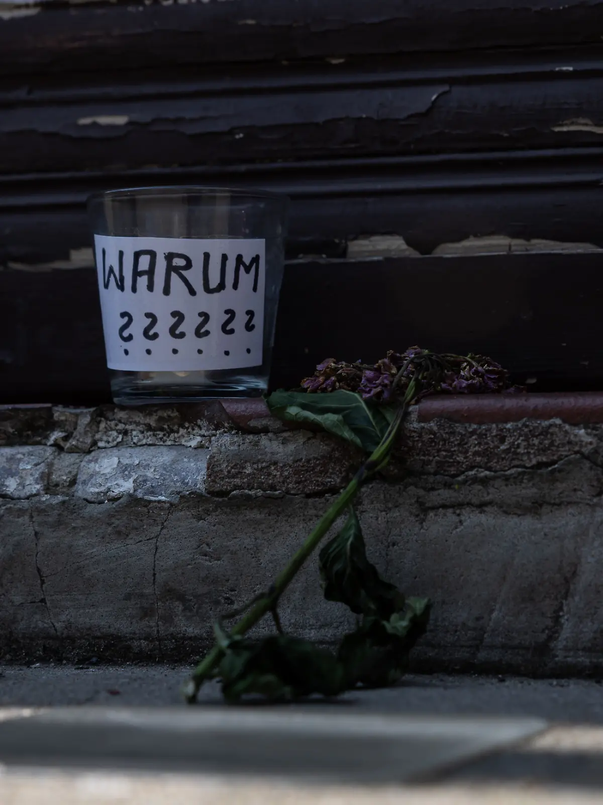 Kerzen und ein Glas mit der Aufschrift „Warum???“ stehen am Tatort nach dem mutmaßlichen Tötungsdelikt in einer Arztpraxis in Berlin-Wedding.