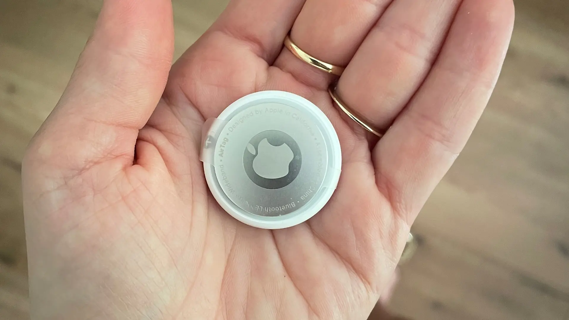 Airtag von Apple auf der Handinnenfläsche.