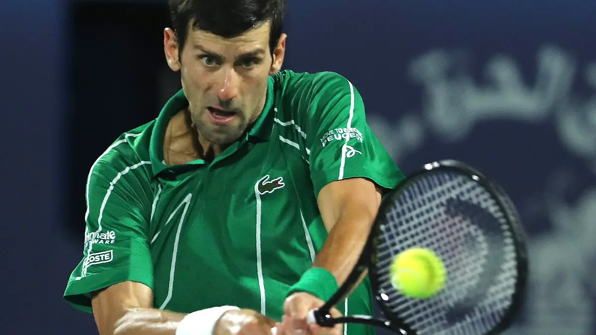 FILE - In this Feb. 29, 2020, file photo, Serbia's Novak Djokovic returns the ball to Stefanos Tsitsipas of Greece during the final match of the Dubai Duty Free Tennis Championship in Dubai, United Arab Emirates. The heads of the ATP and WTA professional tennis tours tell the AP that they are coordinating with each other as they weigh how to reschedule the sport’s calendar for whenever play can resume after the COVID-19 pandemic. (AP Photo/Kamran Jebreili, File)