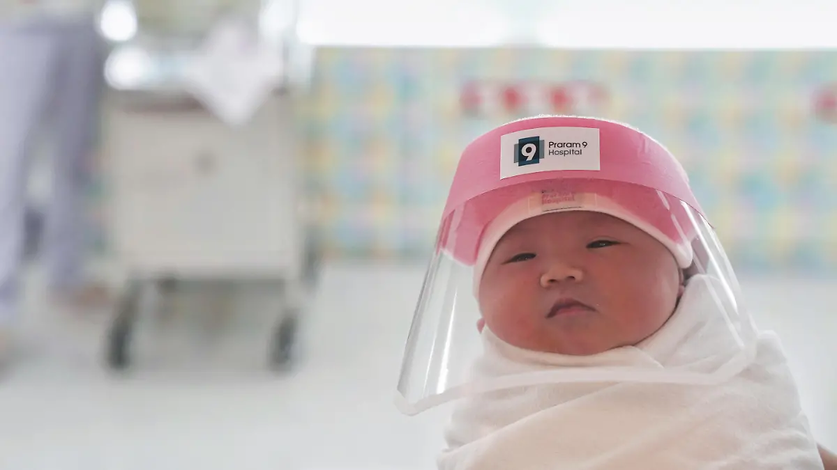 A newborn baby is seen wearing a protective face shield during the coronavirus disease (COVID-19) outbreak at the Praram 9 hospital in Bangkok, Thailand, April 9, 2020. REUTERS/Athit Perawongmetha  